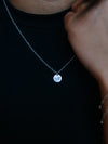 Necklace with a round pendant on a dark background
