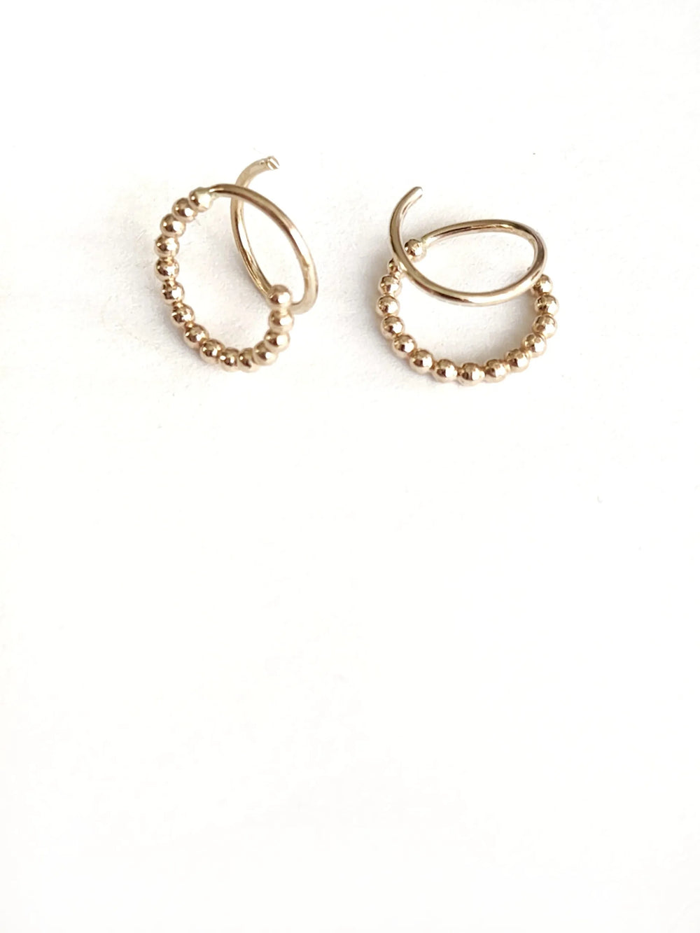 Gold hoop earrings on a white background