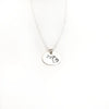 Silver necklace with a round pendant on a white background