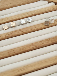 Square studs in a jewelry holder