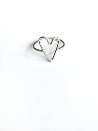 Silver heart-shaped ring on a white background