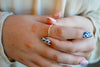 Close-up of a person's hands with painted nails and a ring.